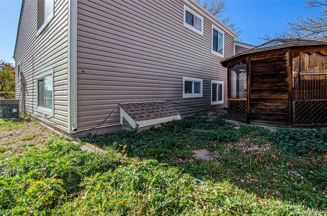 a view of a house with a yard and hanging chair