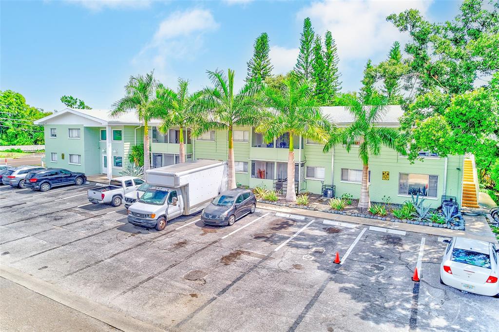 1329 Drew Street, Unit 8 Clearwater, FL 33755 - Photo 15 of 19 a row of palm trees in front of a house