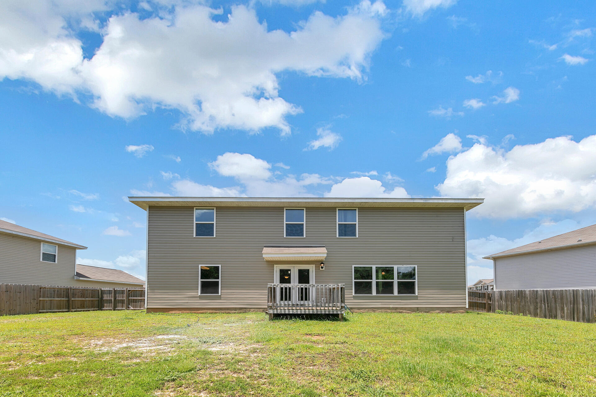 4624 Plover Drive Crestview, FL 32539 - Photo 18 of 34 a house view with swimming pool and trees in the background