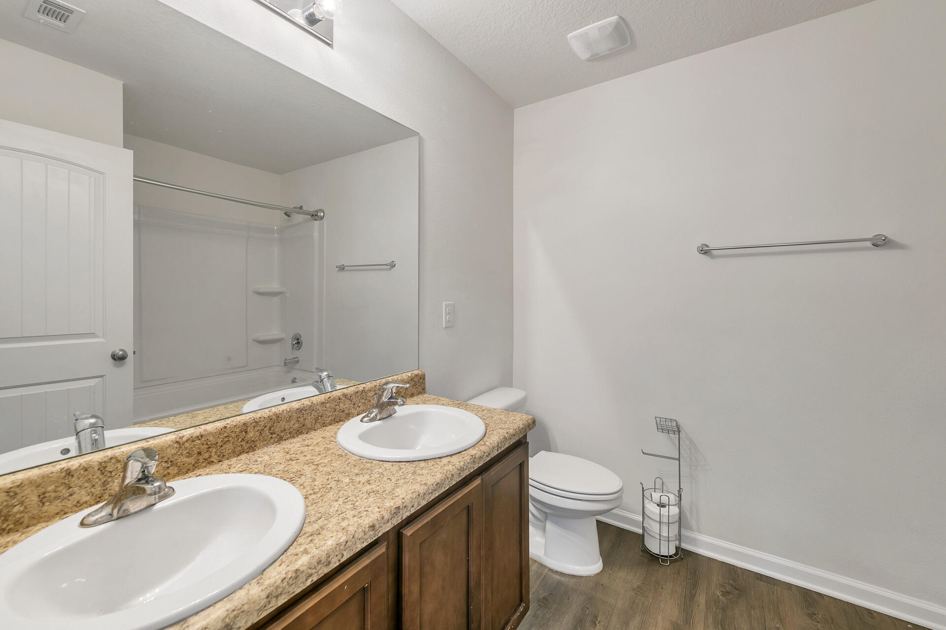 4624 Plover Drive Crestview, FL 32539 - Photo 27 of 34 a bathroom with a granite countertop sink toilet a large mirror and a shower