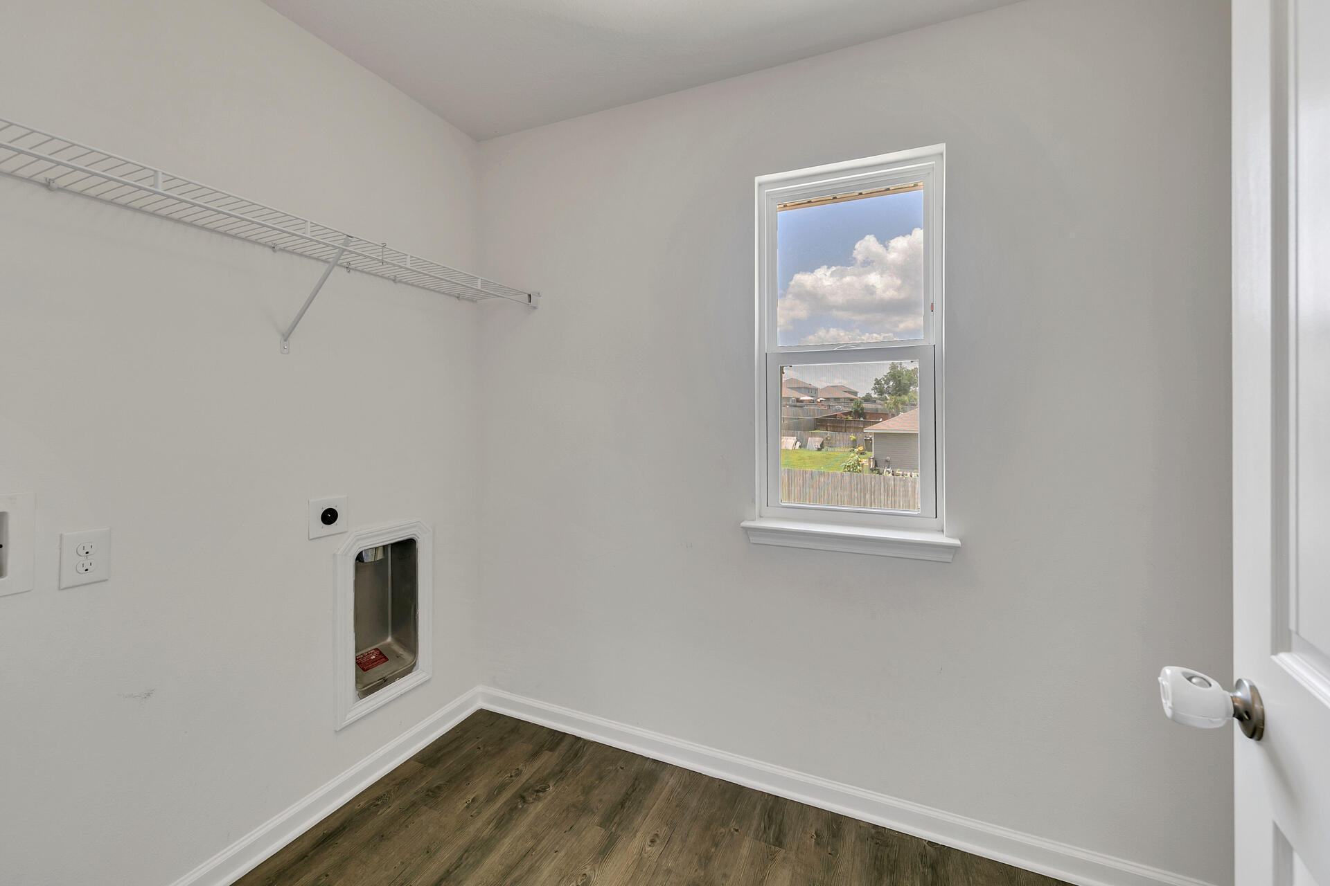 4624 Plover Drive Crestview, FL 32539 - Photo 29 of 34 a view of an empty room with wooden floor and a window