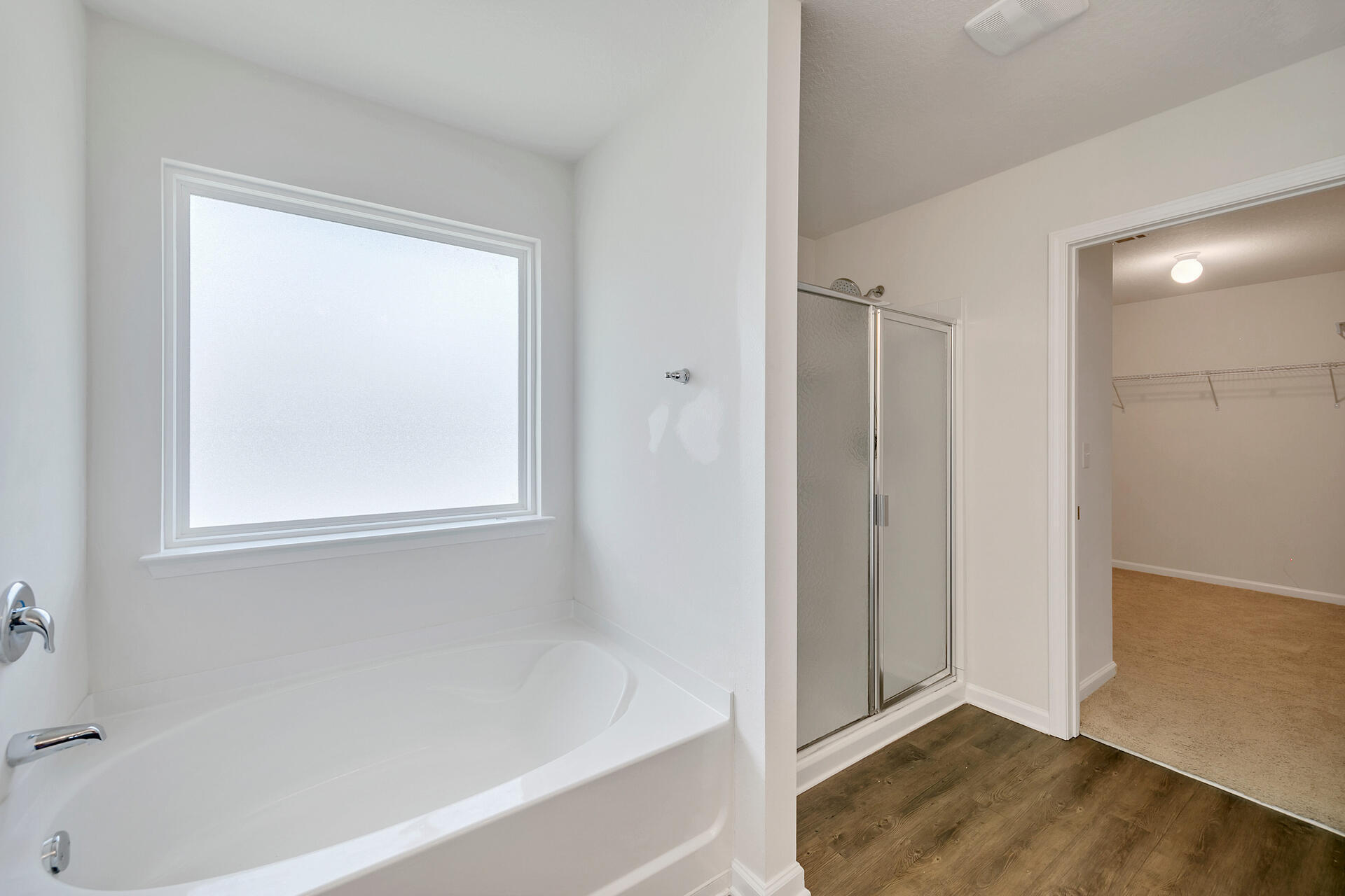 4624 Plover Drive Crestview, FL 32539 - Photo 31 of 34 a view of bathroom with bathtub wooden floor and window