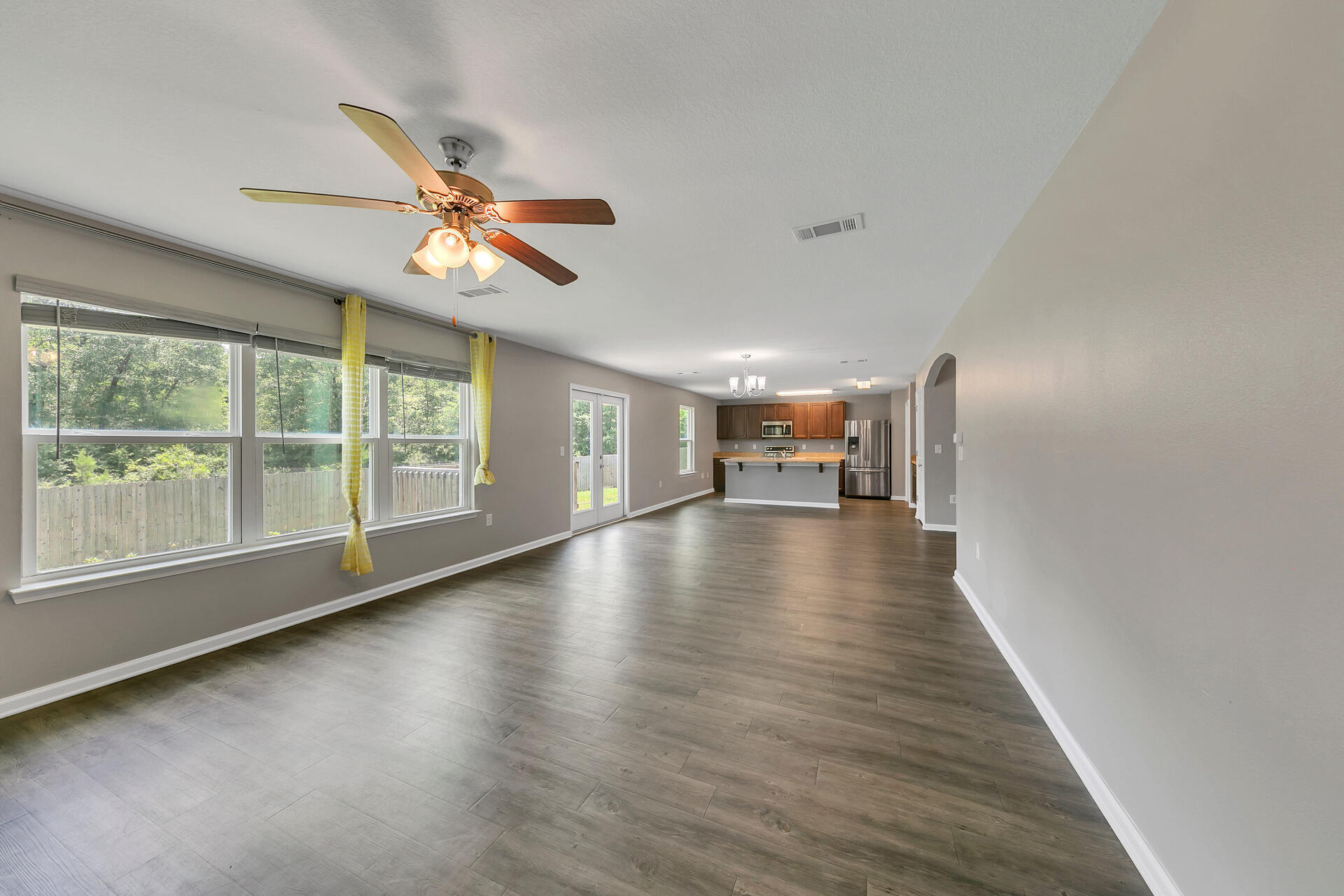 4624 Plover Drive Crestview, FL 32539 - Photo 7 of 34 a view of empty room with wooden floor and fan