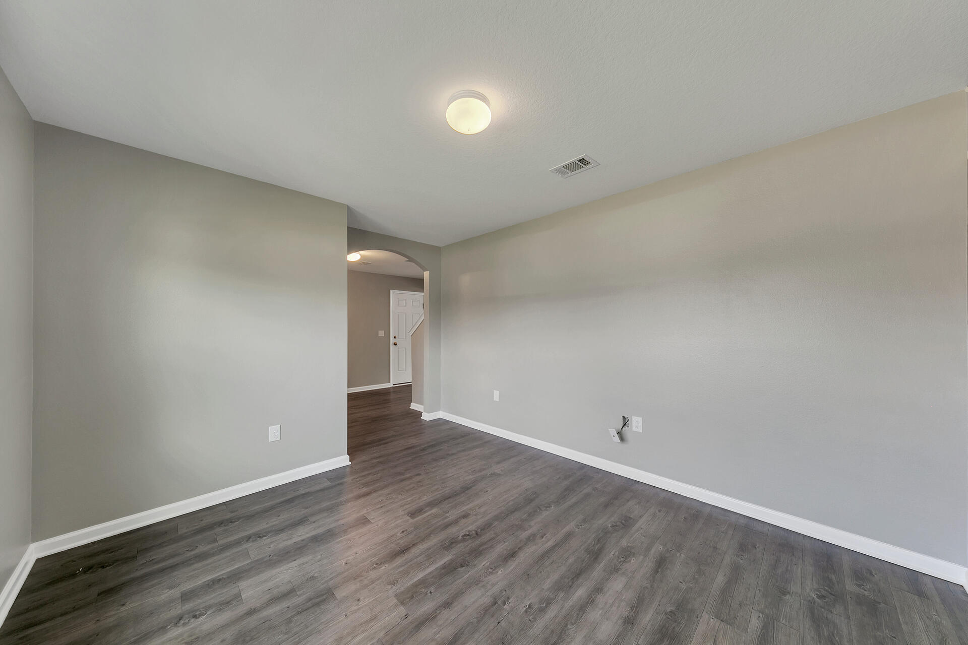 4624 Plover Drive Crestview, FL 32539 - Photo 9 of 34 a view of an empty room with wooden floor