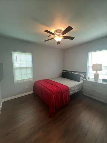 a spacious bedroom with a bed and a chandelier