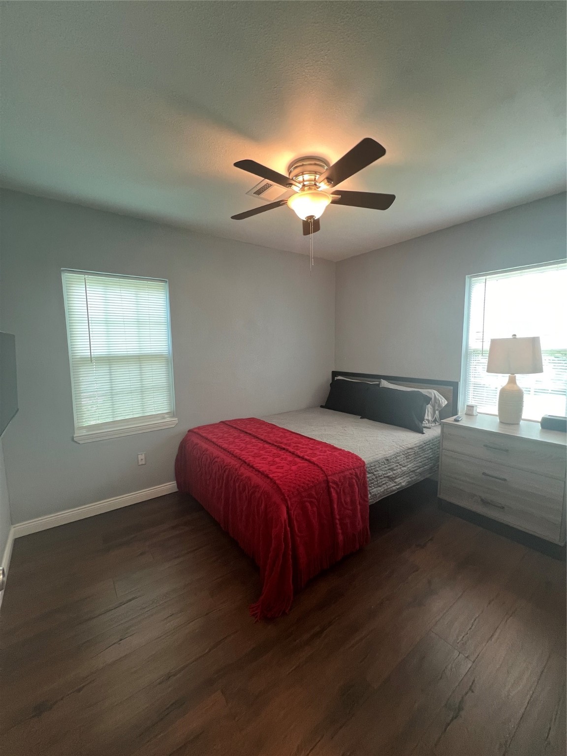 3001 Austin Street Vidor, TX 77662 - Photo 10 of 14 a spacious bedroom with a bed and a chandelier