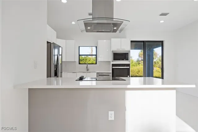 a bathroom with a sink a large mirror and a window