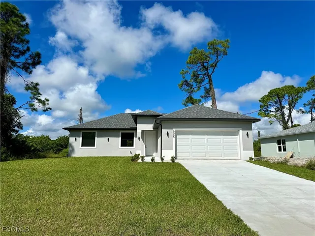 a front view of a house with a yard and garage