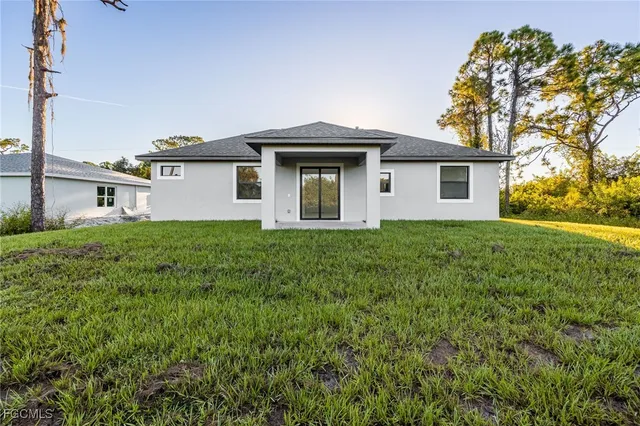 a house that has a tree in front of it