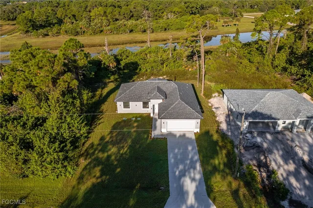 an aerial view of a house with a yard