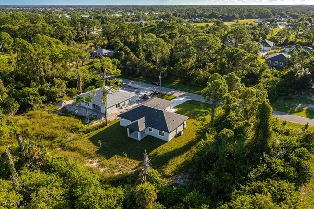 an aerial view of residential house with yard and swimming pool