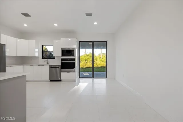 a view of a kitchen with a sink and a stove top oven