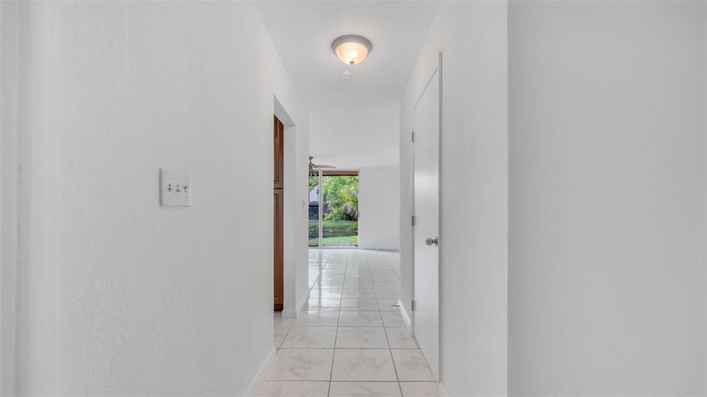 1153 Hampton Boulevard North Lauderdale, FL 33068 - Photo 8 of 10 a view of a hallway with wooden shelves