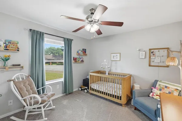 a view of a livingroom with furniture and a ceiling fan