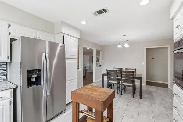 a kitchen with stainless steel appliances kitchen island granite countertop a stove a sink and a microwave