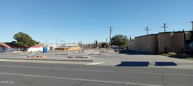 a view of a yard with snow on the road
