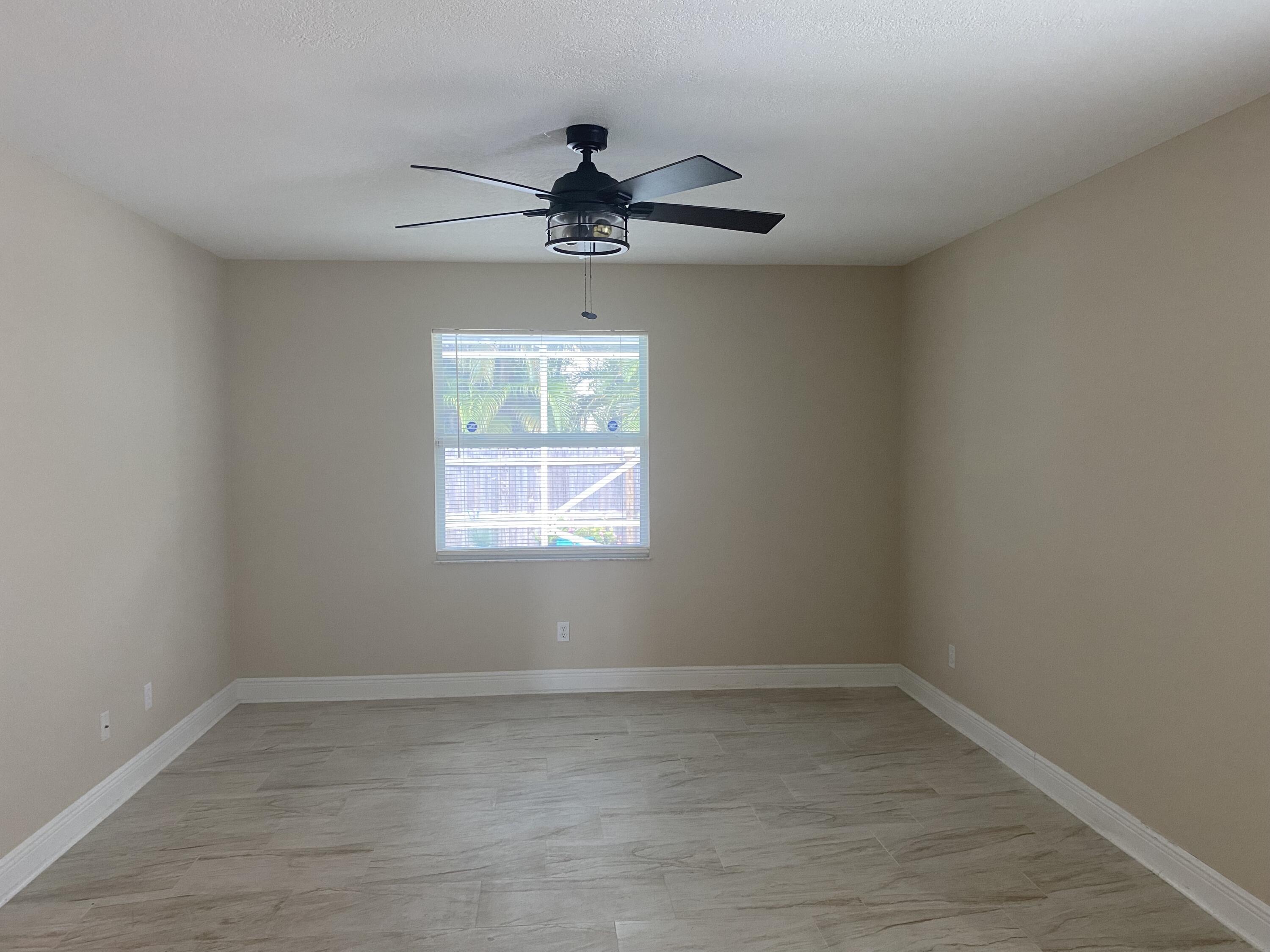 3196 Southwest Areca Drive Palm City, FL 34990 - Photo 11 of 21 wooden floor in an empty room with a window