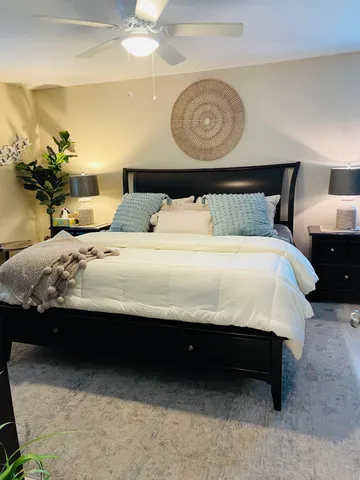 a bedroom with a bed and a chandelier