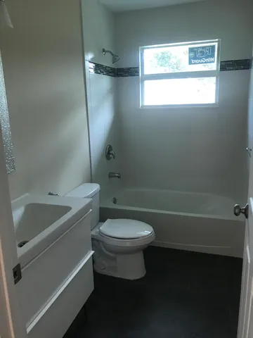a bathroom with a sink a toilet and a bathtub