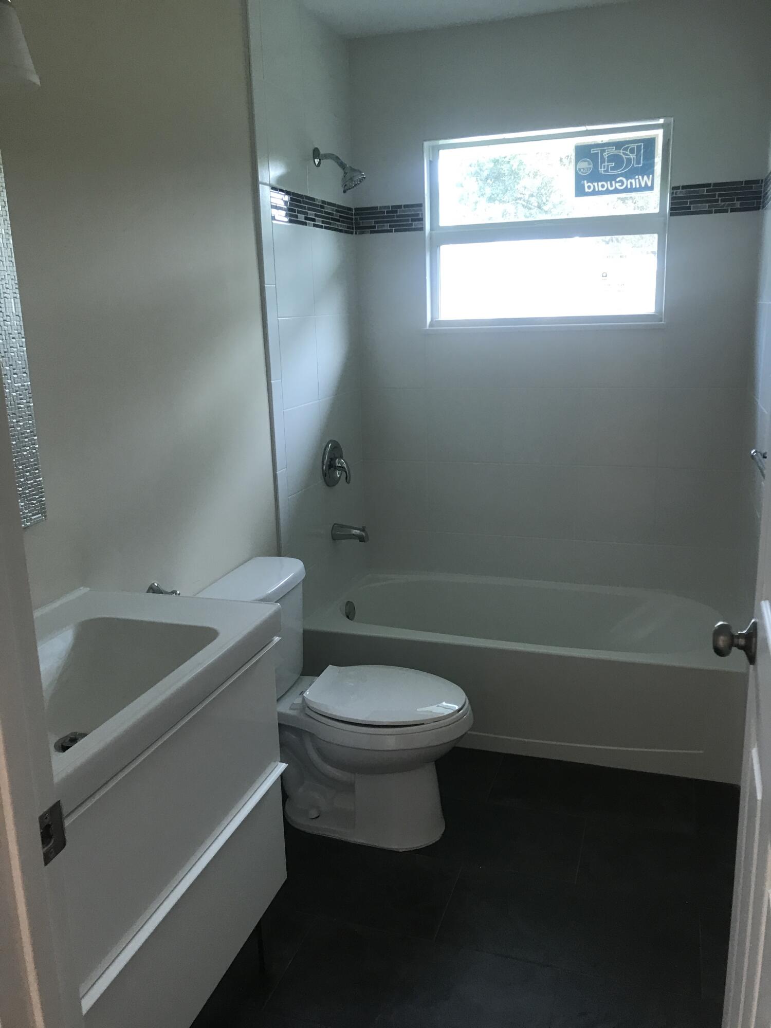 3196 Southwest Areca Drive Palm City, FL 34990 - Photo 18 of 21 a bathroom with a sink a toilet and a bathtub