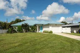 a view of a house with a yard and garage
