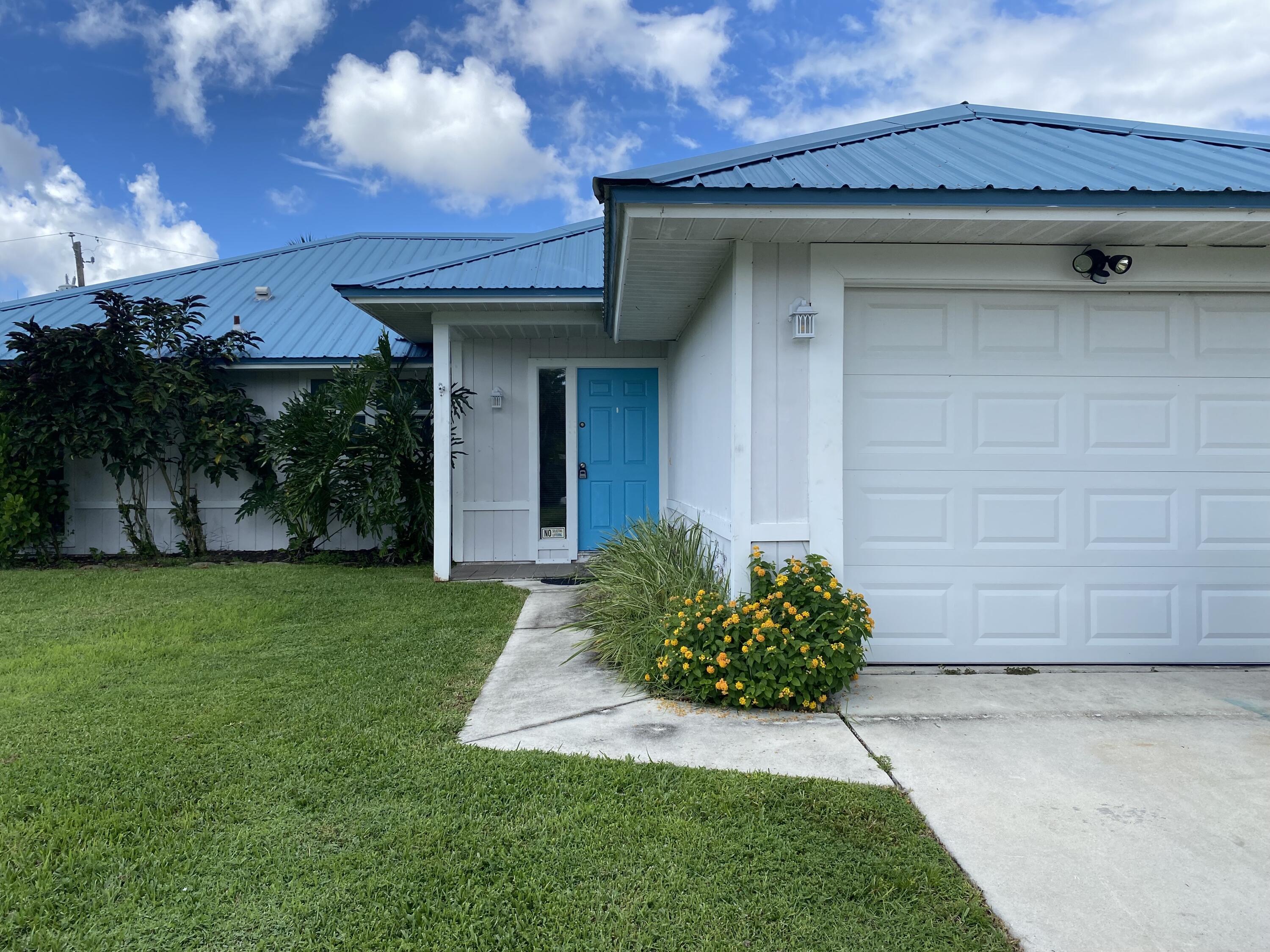 3196 Southwest Areca Drive Palm City, FL 34990 - Photo 3 of 21 a front view of a house with garden