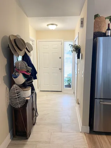 a view of hallway with cabinets and wooden floor