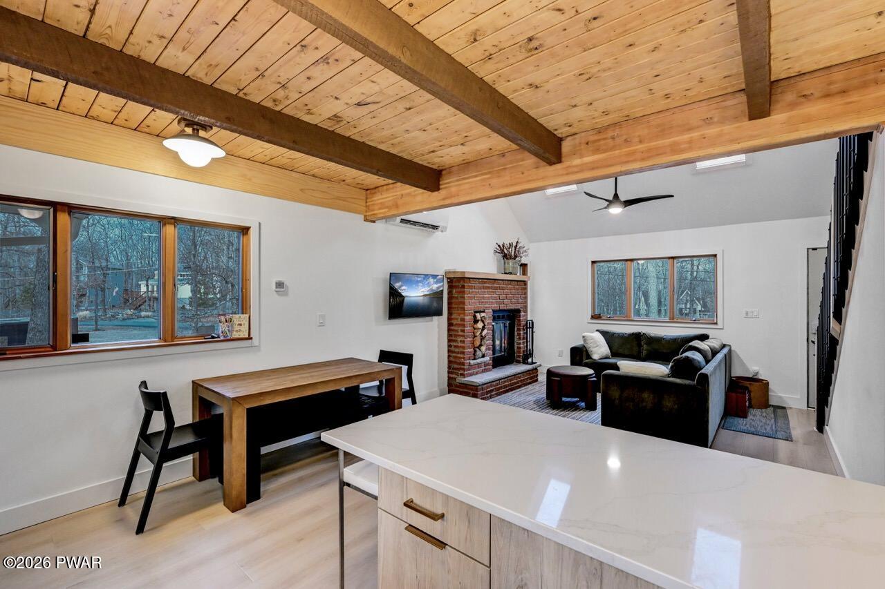 258 Lakeview Road Lackawaxen, PA 18435 - Photo 23 of 119 a living room with furniture a large window and kitchen view