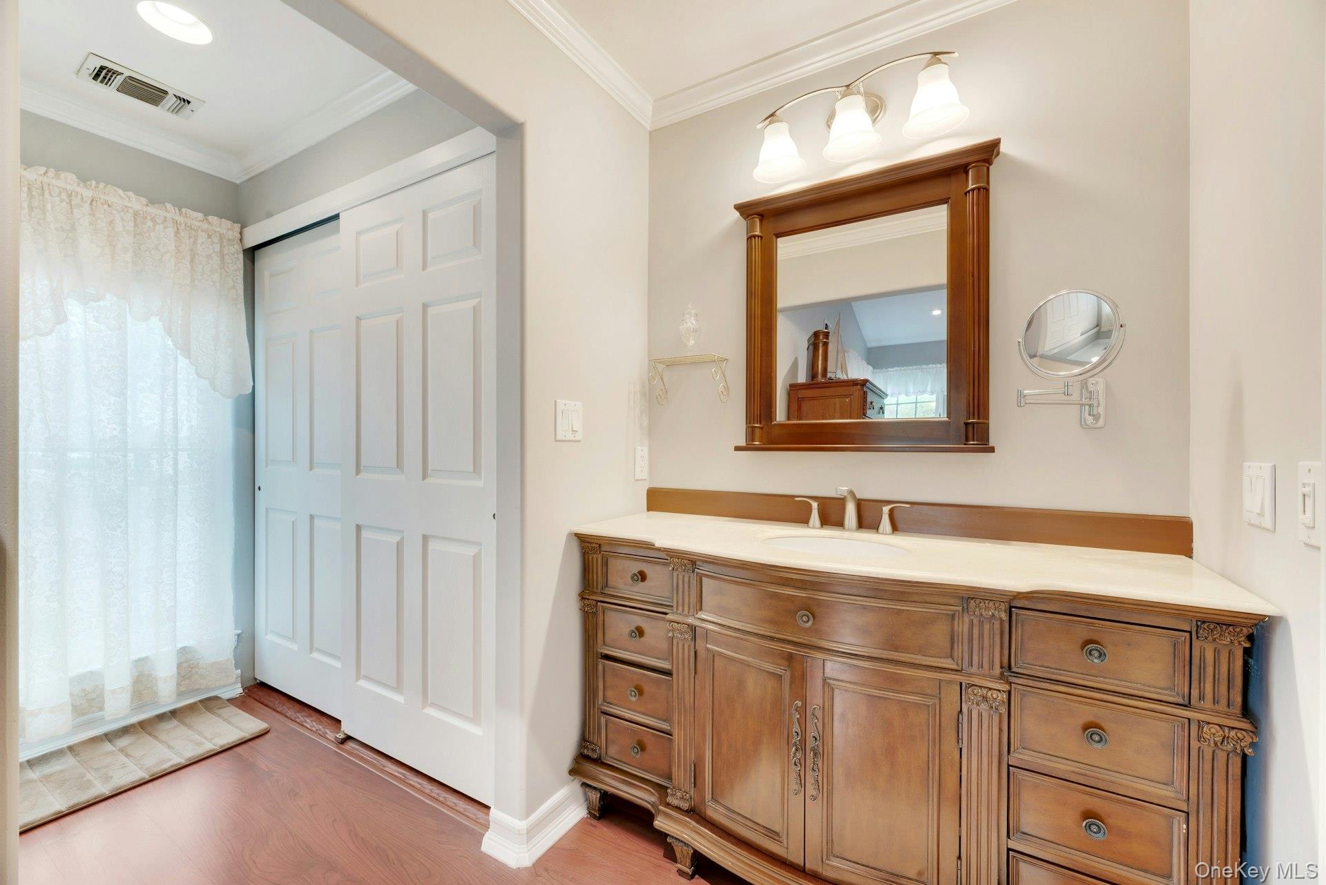 104 Glen Drive Ridge, NY 11961 - Photo 21 of 25 a bathroom with a sink mirror and vanity