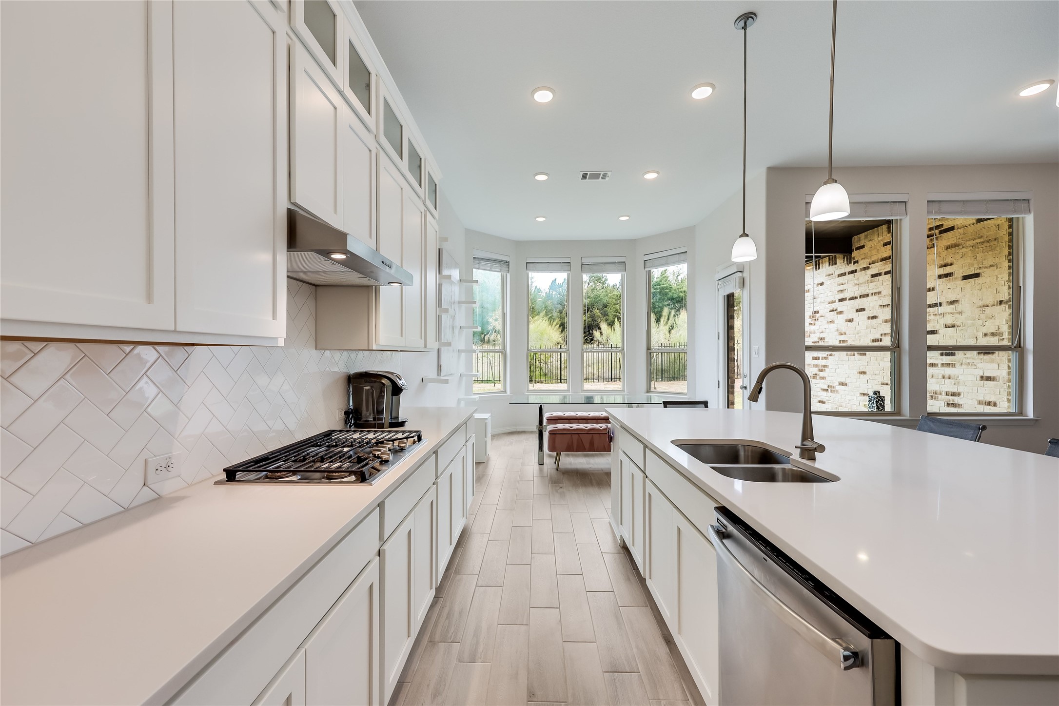 7705 Pace Ravine Drive Lago Vista, TX 78645 - Photo 7 of 40 Kitchen featuring glass fronted cabinets, white cabinetry, an island with sink, and stainless steel appliances