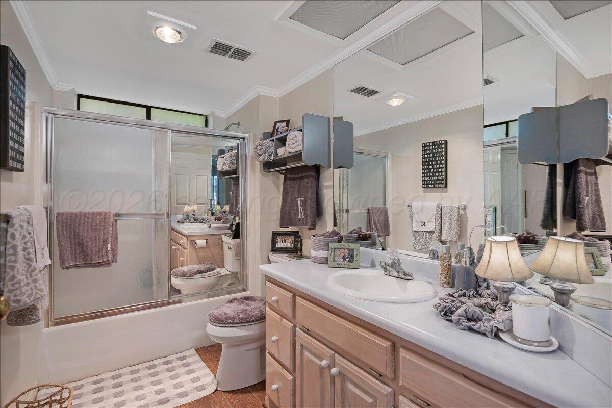 5 Locke Place Amarillo, TX 79124 - Photo 30 of 53 a bathroom with a double vanity sink toilet mirror and shower