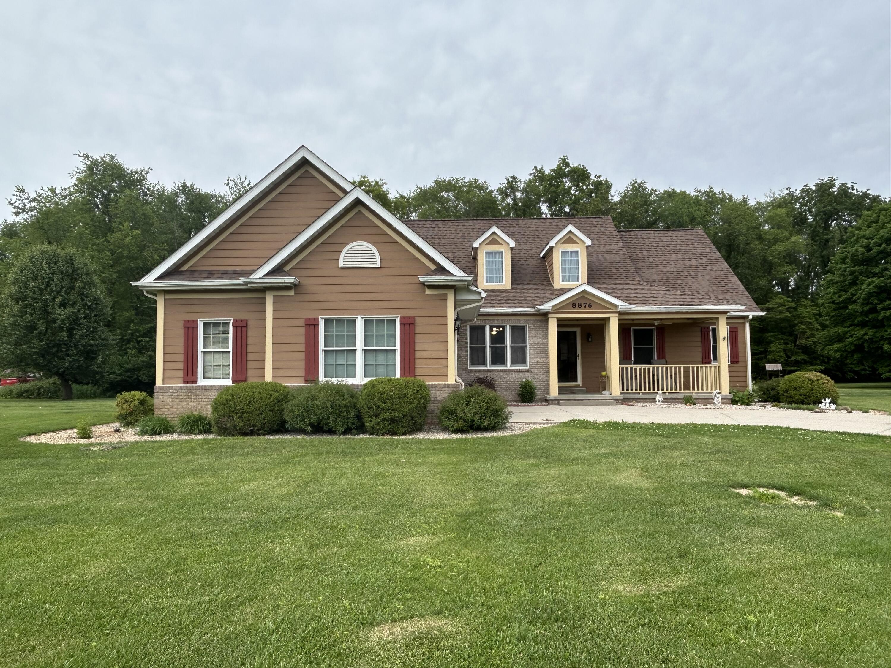 a front view of a house with a garden