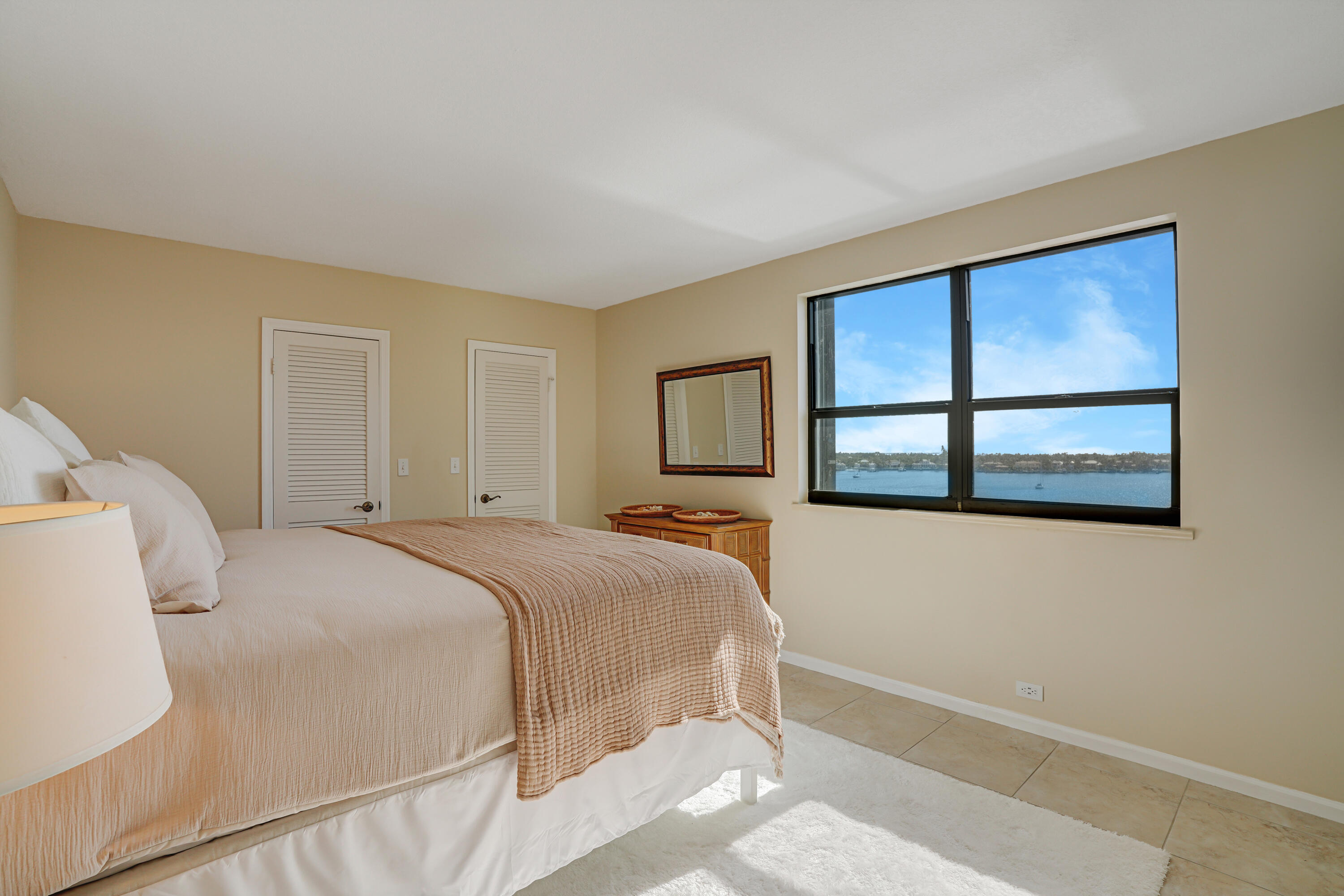 1208 Marine Way, Unit 602 North Palm Beach, FL 33408 - Photo 14 of 25 a bedroom with a bed and a window