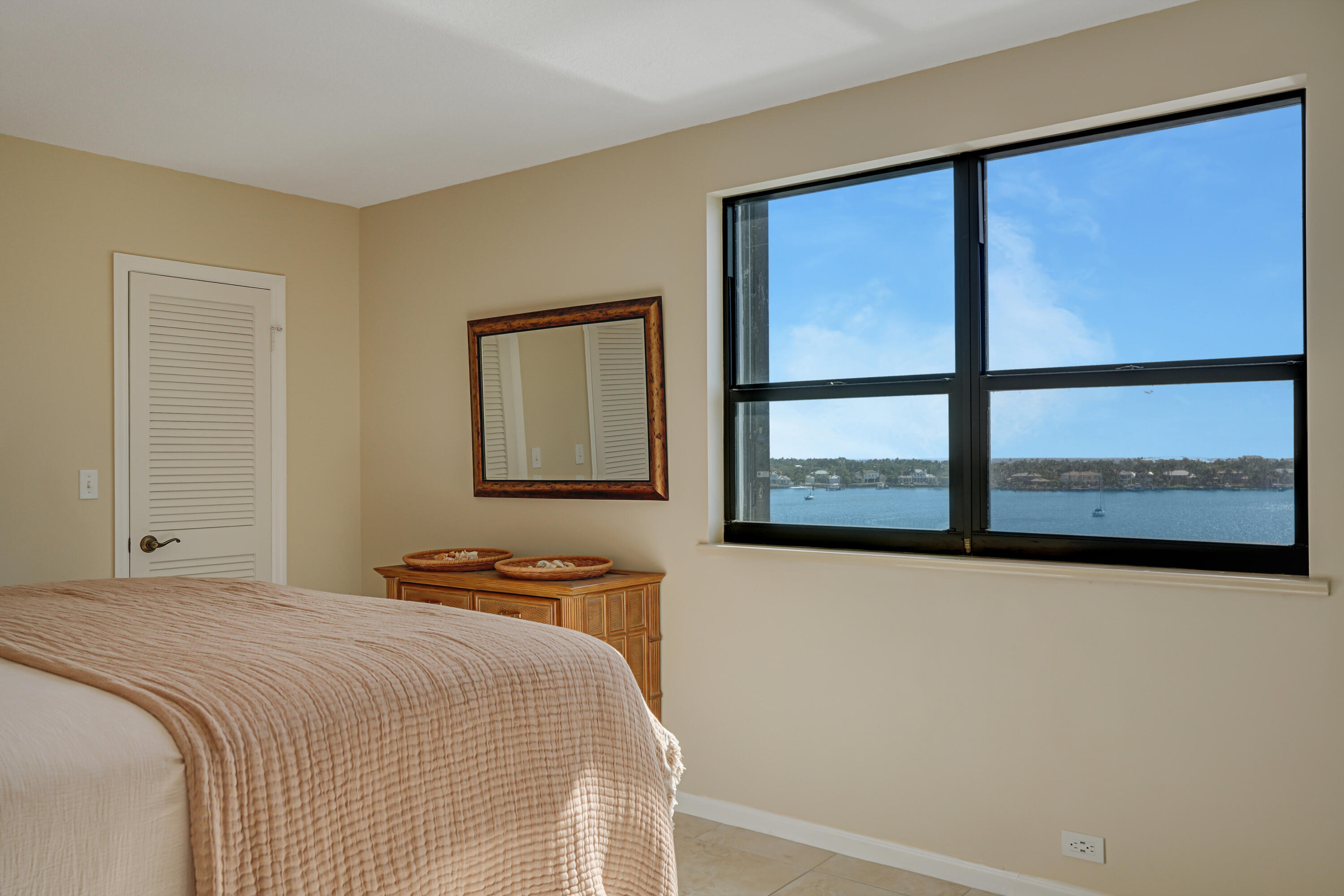 1208 Marine Way, Unit 602 North Palm Beach, FL 33408 - Photo 15 of 25 a bedroom with a bed and a window