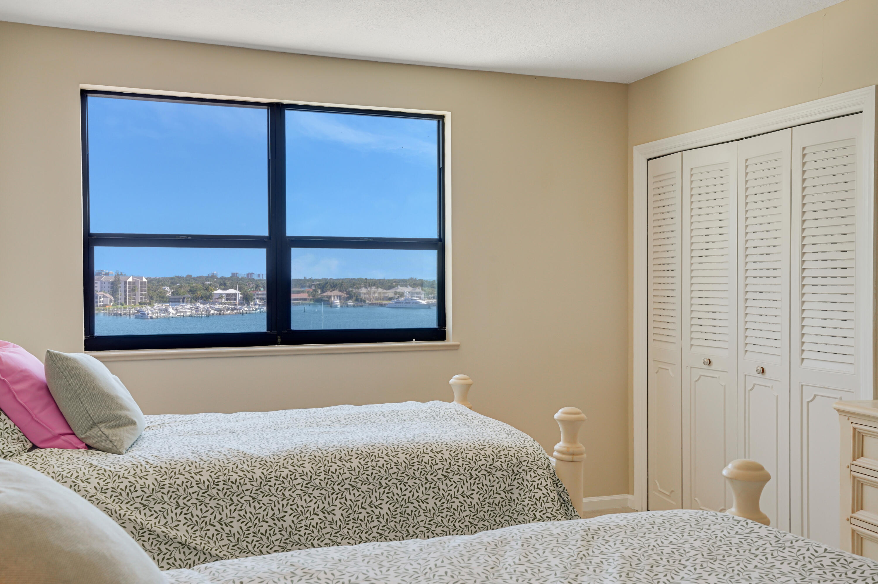 1208 Marine Way, Unit 602 North Palm Beach, FL 33408 - Photo 17 of 25 a bed sitting in a bedroom next to a window