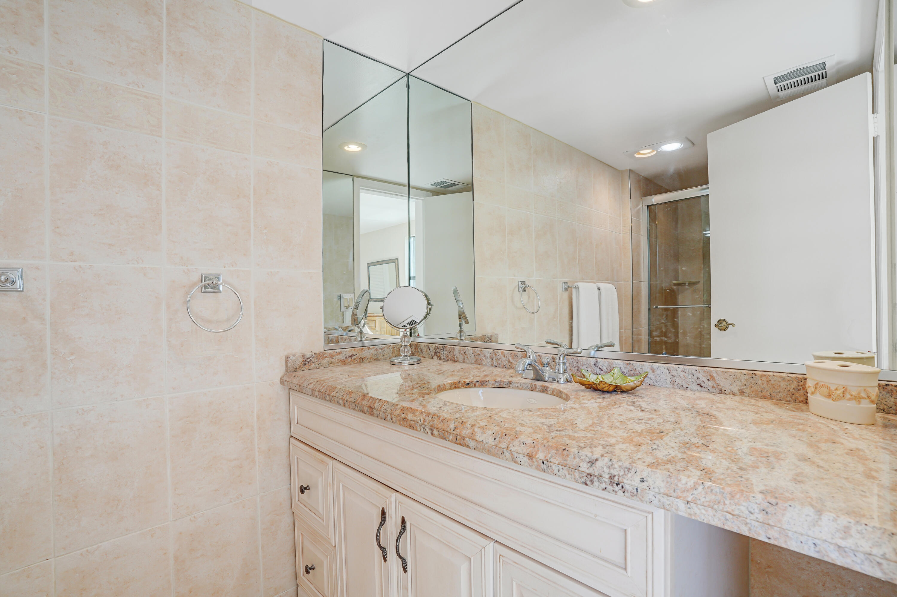 1208 Marine Way, Unit 602 North Palm Beach, FL 33408 - Photo 19 of 25 a bathroom with a granite countertop sink and a mirror