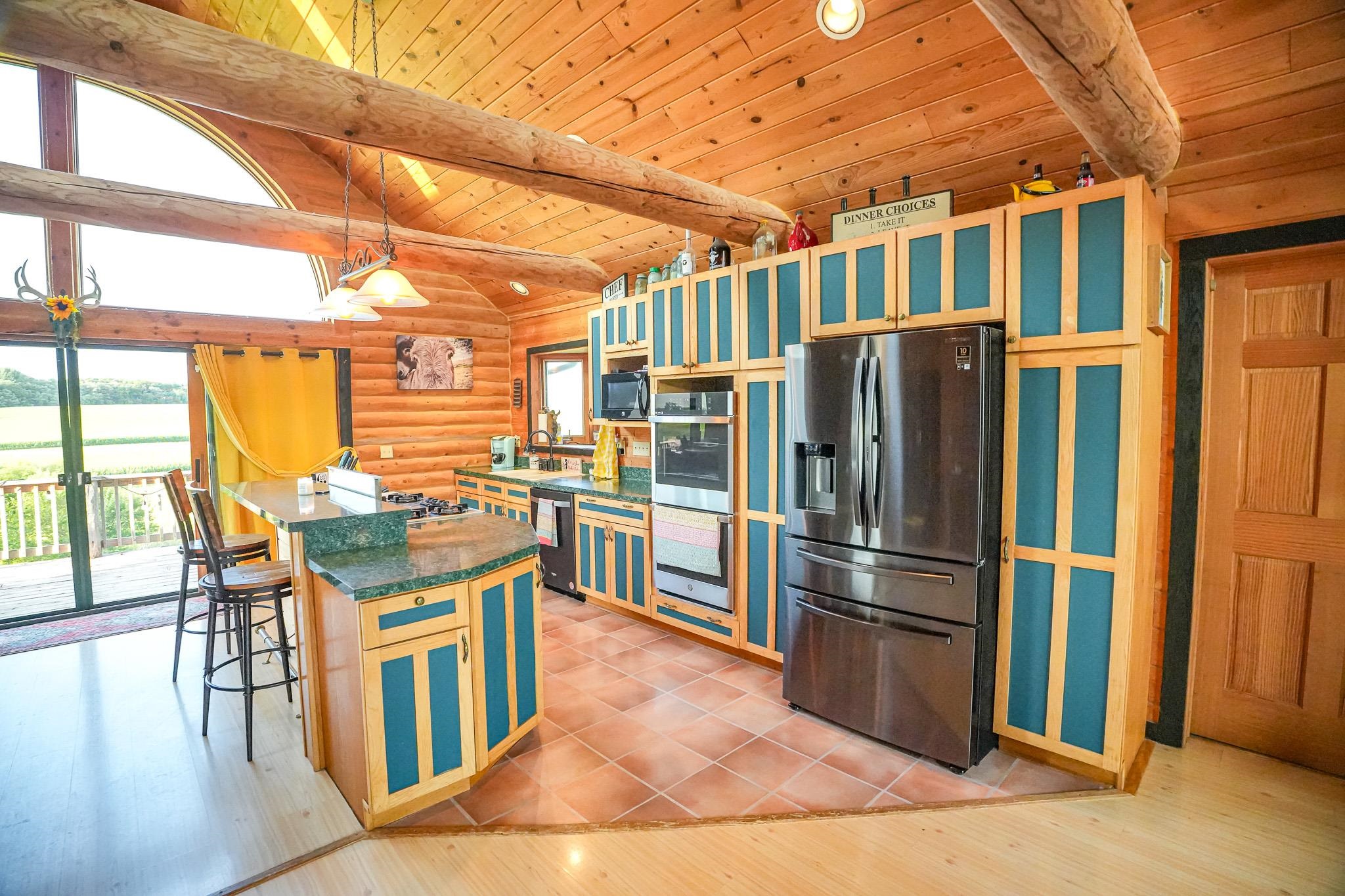 976 Paw Paw Road Paw Paw, IL 61353 - Photo 13 of 79 a kitchen with stainless steel appliances granite countertop a refrigerator a stove top oven a dining table and chairs with wooden floor