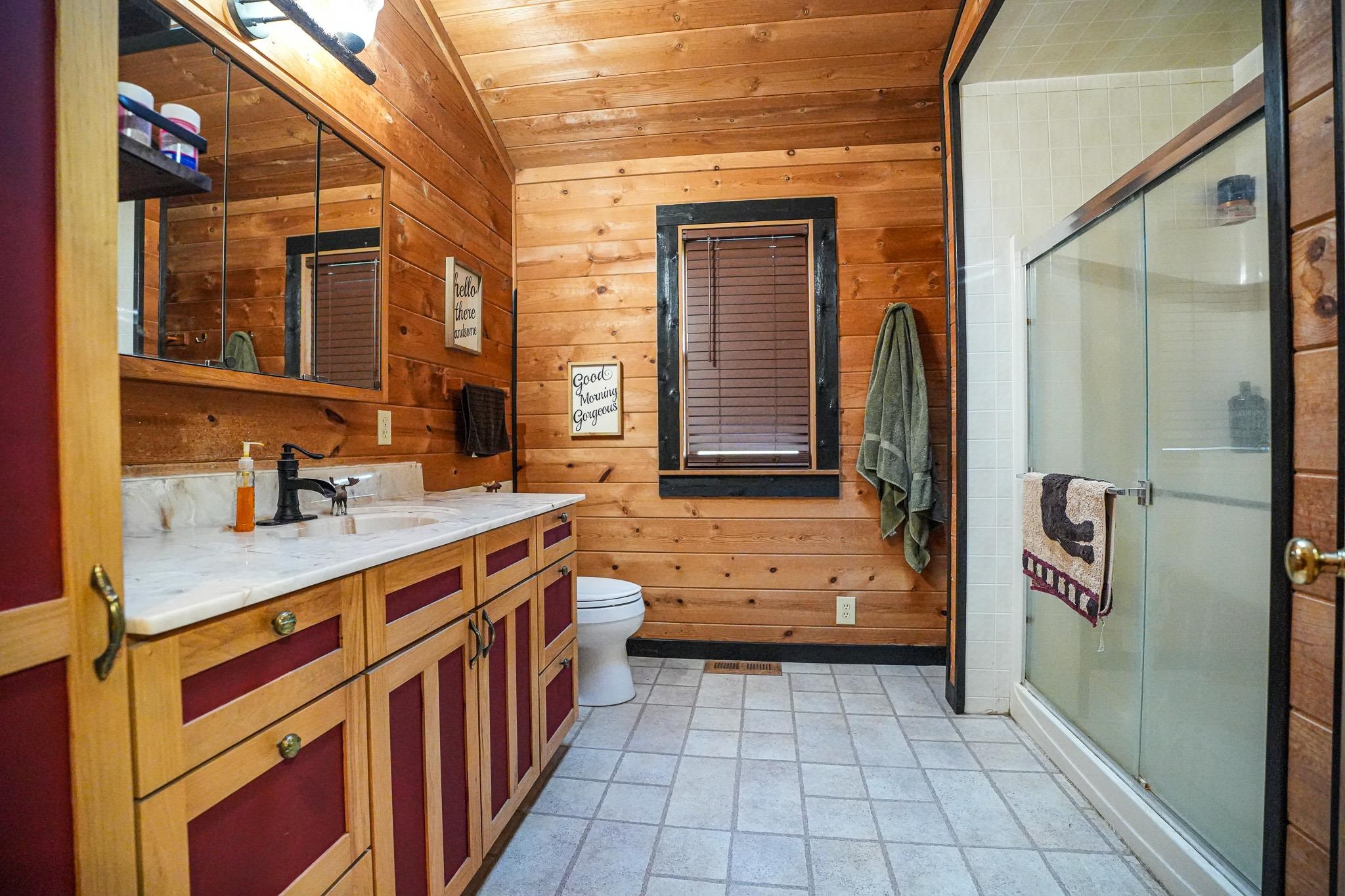 976 Paw Paw Road Paw Paw, IL 61353 - Photo 26 of 79 a bathroom with a granite countertop sink a mirror and a bathtub