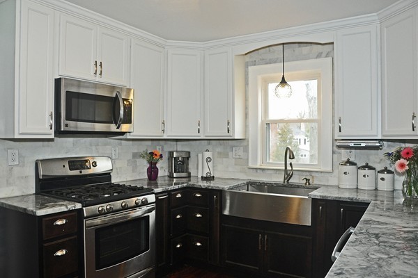 1188 Brook Road Milton, MA 02186 - Photo 7 of 12 a kitchen with stainless steel appliances granite countertop a sink stove and microwave