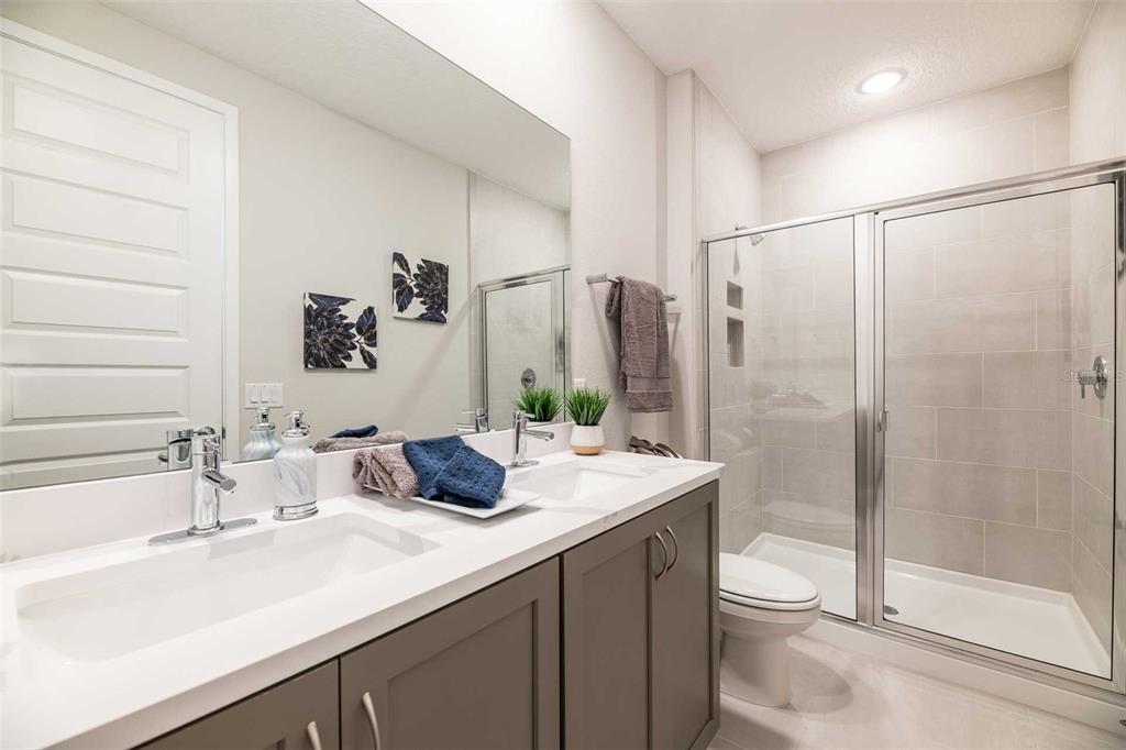 7920 Spectrum Drive Kissimmee, FL 34747 - Photo 8 of 13 a bathroom with a sink a toilet and shower