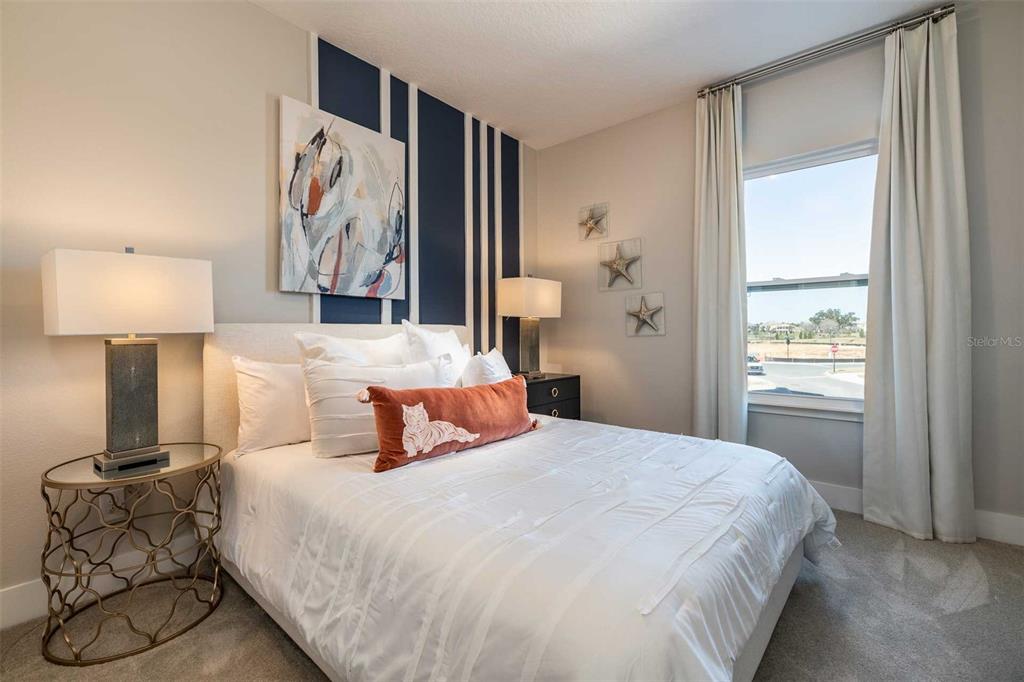 7920 Spectrum Drive Kissimmee, FL 34747 - Photo 9 of 13 a bedroom with a bed and lamp