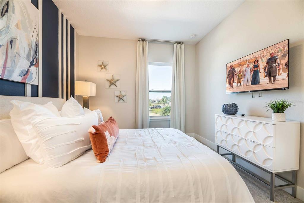 7920 Spectrum Drive Kissimmee, FL 34747 - Photo 10 of 13 a bedroom with a bed painting on wall and a large window