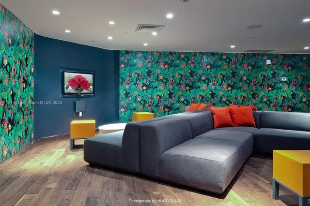 a living room with furniture and a potted plant