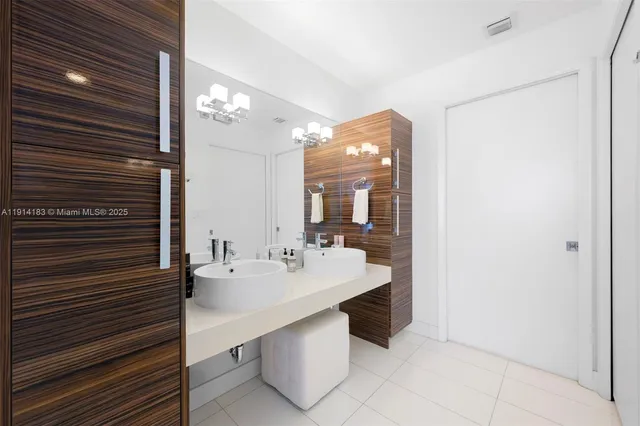a spacious bathroom with a sink a mirror and shower