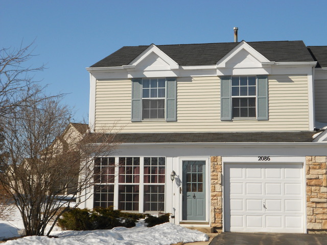 2086 Muirfield Circle, Unit 2086 Elgin, IL 60123 - Photo 1 of 1 a front view of a house with a yard