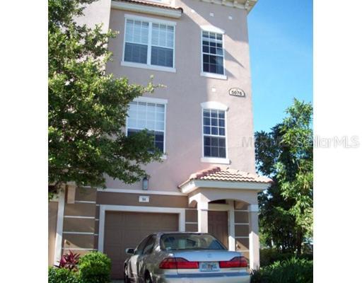 5076 Tideview Circle, Unit 94 Orlando, FL 32819 - Photo 1 of 1 a front view of a house with a garden