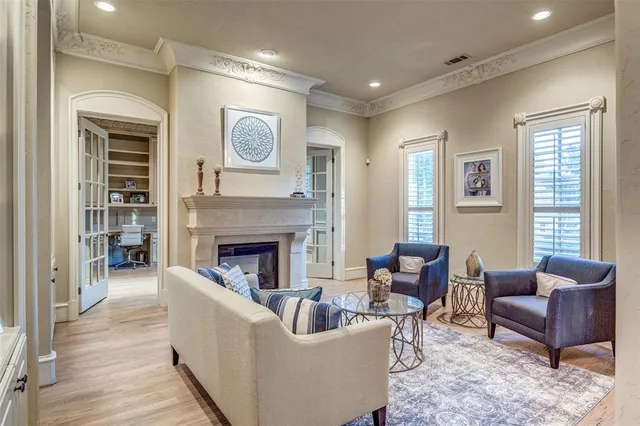 a bedroom with furniture and a large window