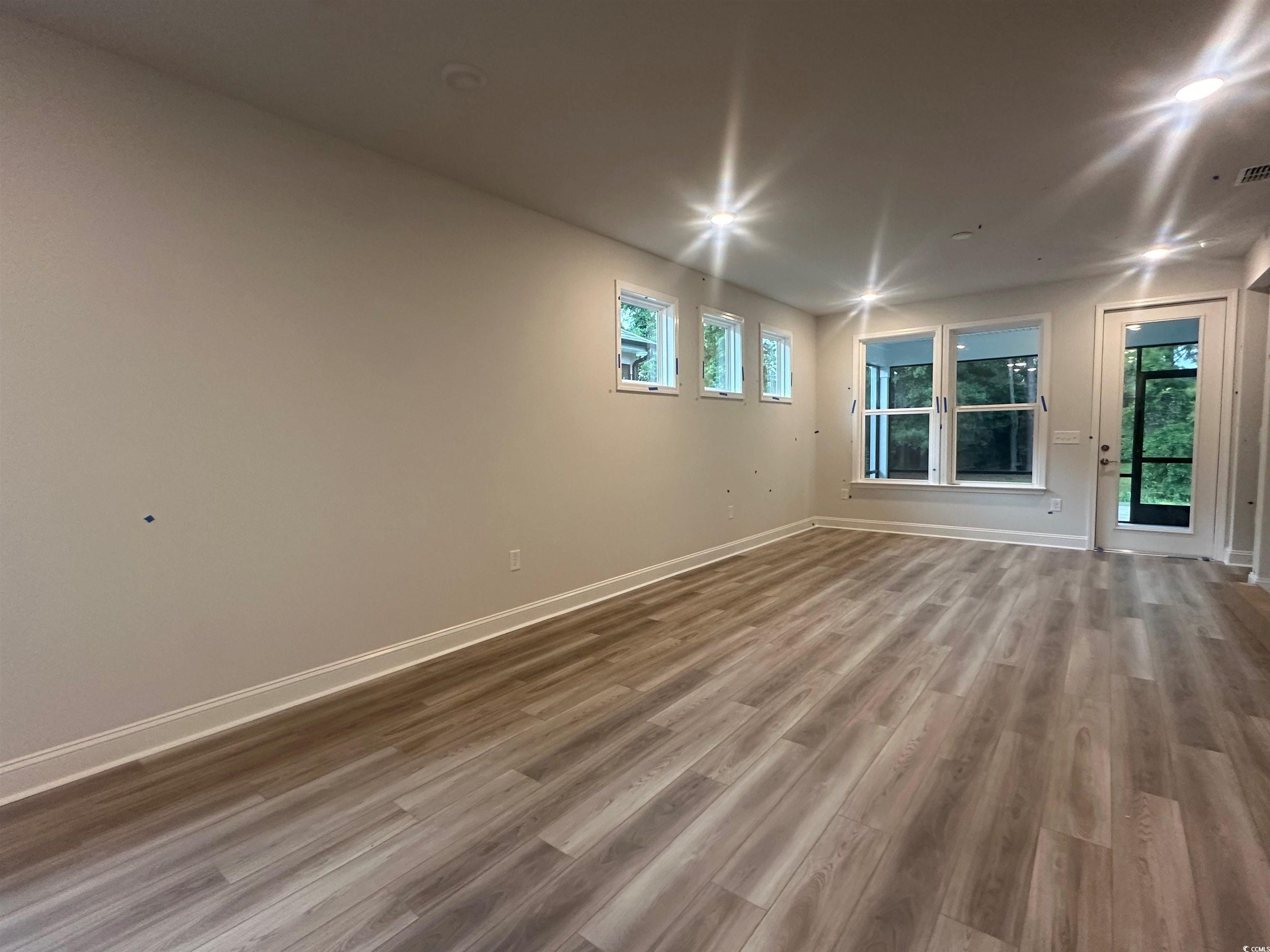 1541 Littleleaf Loop North Myrtle Beach, SC 29582 - Photo 6 of 19 Spare room featuring hardwood / wood-style floorin