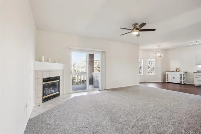 a view of a livingroom with a fireplace and window