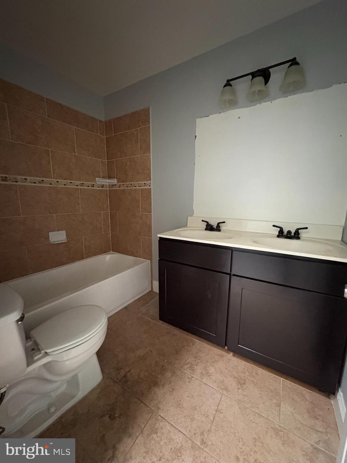 3413 Noble Street Baltimore, MD 21224 - Photo 12 of 43 a bathroom with a sink a toilet and bathtub